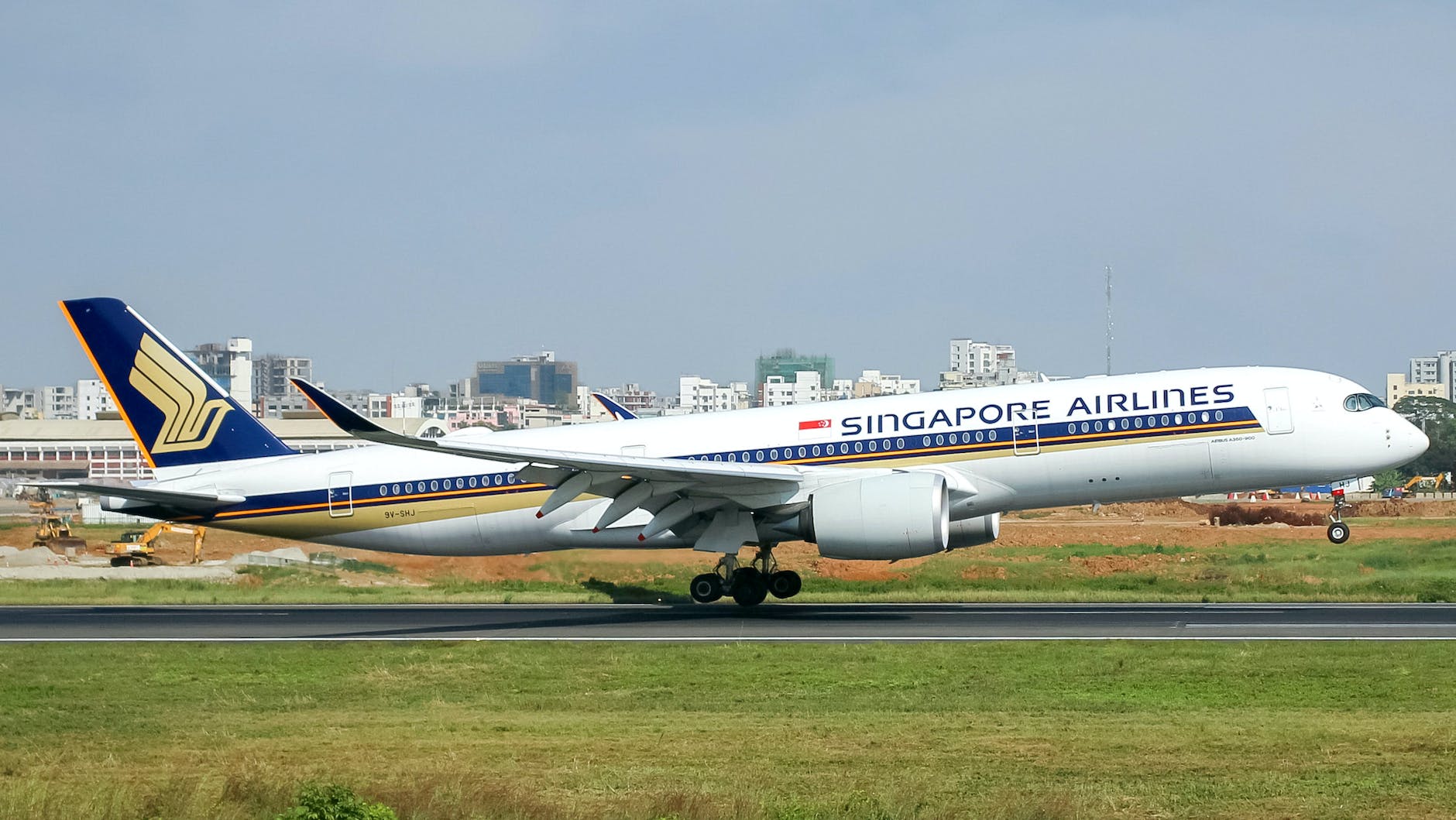 white and blue passenger plane on runway