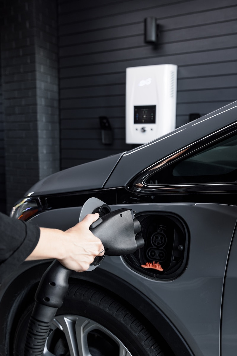 a woman is pumping gas into her car