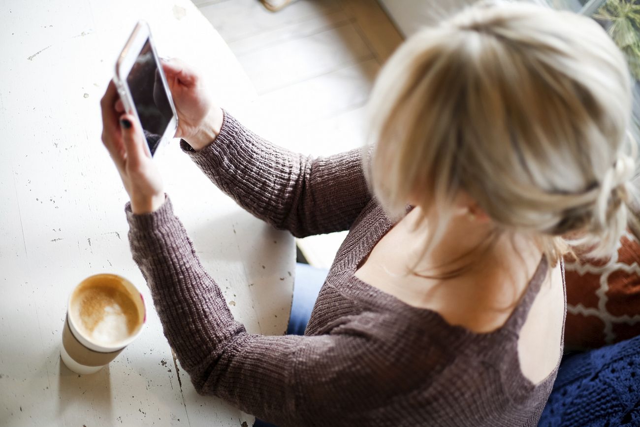 Free woman browsing smartphone photo